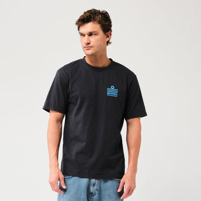 Man wearing a black Admiral t-shirt with an Admiral ensign blue logo on a light grey background